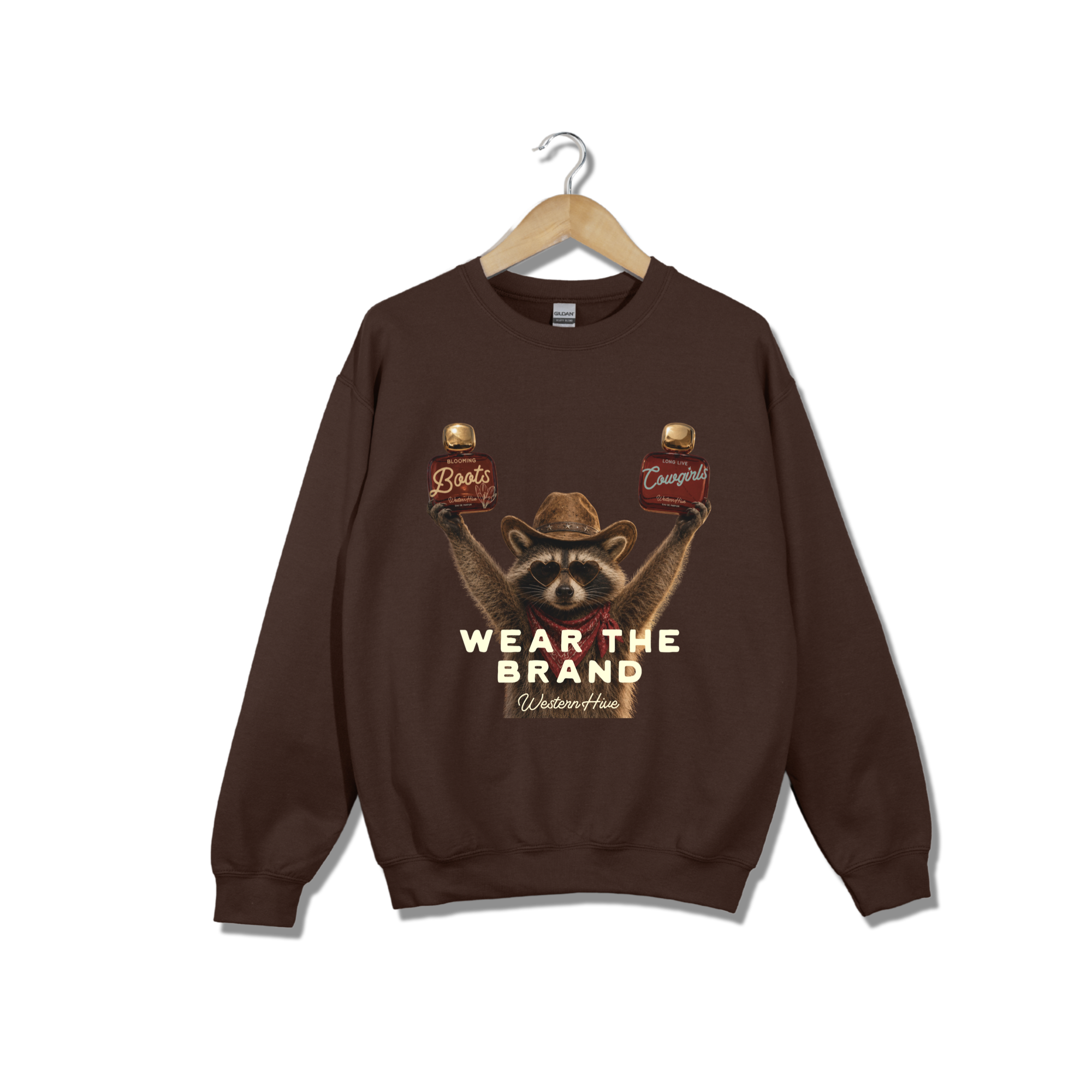 The sweatshirt features a graphic of a raccoon wearing a cowboy hat and holding two Western Hive perfumes &